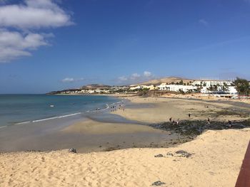 Scenic view of beach against blue sky