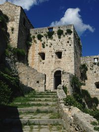 Low angle view of old ruin building against sky