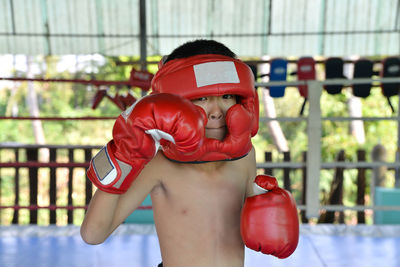 Portrait of shirtless boy in practicing boxing