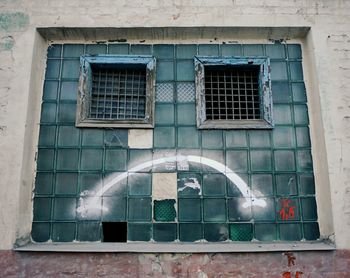 Low angle view of window on building with sad smile 