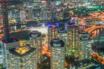 High angle view of illuminated buildings in city at night