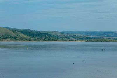 Scenic view of sea against blue sky