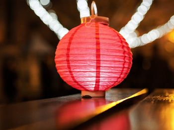 Close-up of hand holding lantern hanging