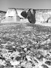 View of rock formation in sea against sky