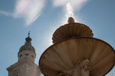 Low angle view of cathedral and fountain  against sky