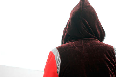 Rear view of woman standing against white background