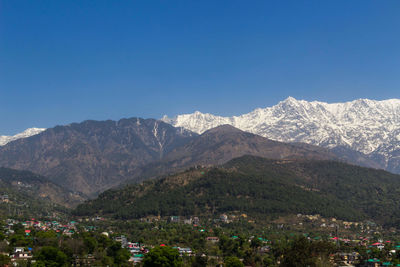 Scenic view of mountains against clear blue sky