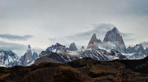 Scenic view of mountains against cloudy sky