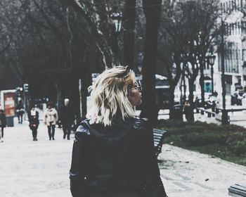 Woman standing on street in city