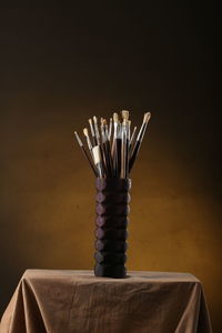 Close-up of stack on table against black background