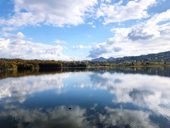 Scenic view of lake by trees against sky