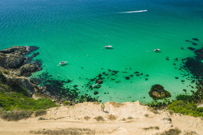 Man traveler, bounty beach with crystal clear azure sea. cape fiolent in sevastopol. aerial view