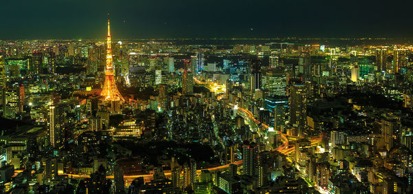 High angle view of illuminated city buildings at night