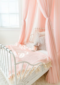 Pink little girls bed with stuffed animal