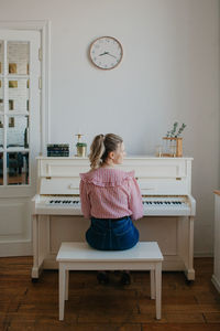 Young beautiful woman playing the piano. high quality photo
