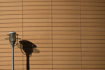 Low angle view of cables against brick wall