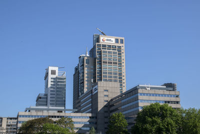 Low angle view of buildings against clear blue sky