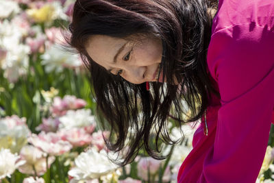 Close-up of woman with pink flower