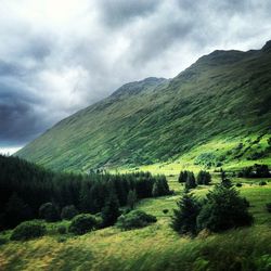 Scenic view of mountains against cloudy sky