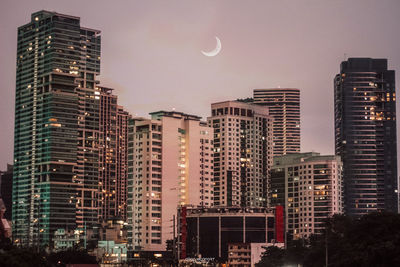 Low angle view of buildings against sky at night