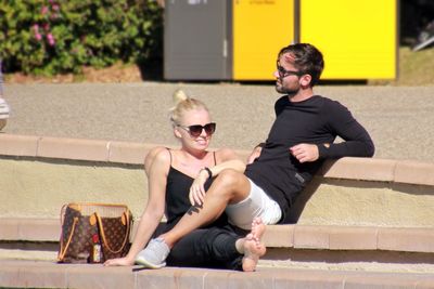 Full length of young woman sitting on ground