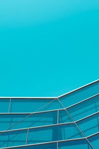 Low angle view of blue building on sunny day