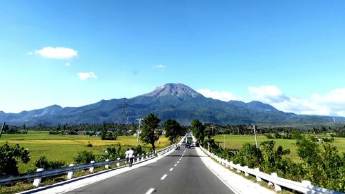 Country road leading towards mountains