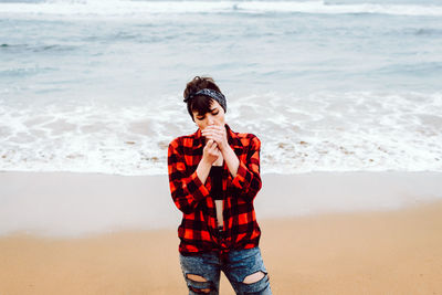 Young man standing on beach