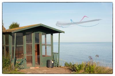 Built structure on beach against sky