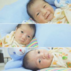 Portrait of cute baby boy lying on bed