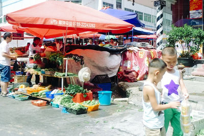 Clothes hanging on street at market stall