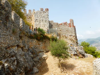 Old ruins by building against sky