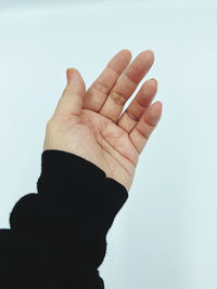 Cropped hand gesturing against white background