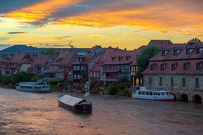 Boats in river with buildings in background