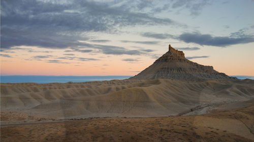 View of desert against cloudy sky