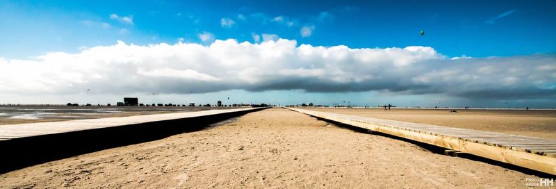 View of beach against cloudy sky