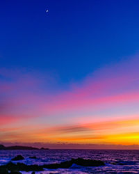 Scenic view of sea against sky at sunset