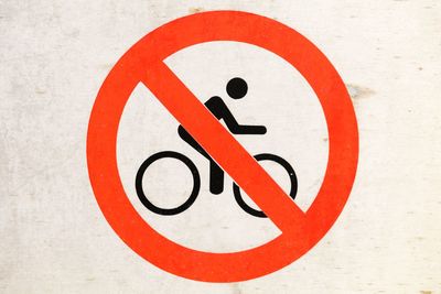 Close-up of no bicycle allowed sign on wall