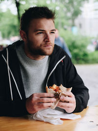 Man eating food on table