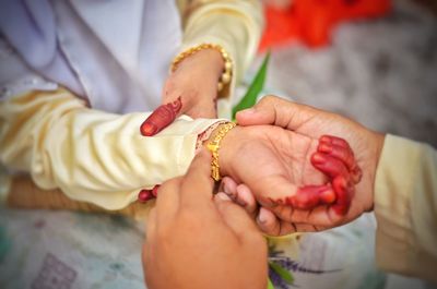 Midsection of couple holding hands