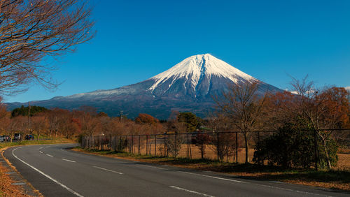 View of mountain road against blue sky