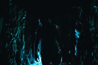 Man standing on field at night