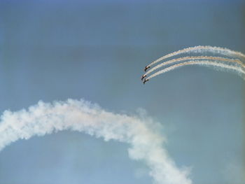 Low angle view of airplane in flight against sky