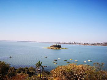 Scenic view of sea against clear blue sky