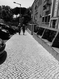 People walking on sidewalk in city