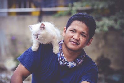 Portrait of woman holding cat