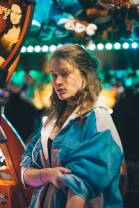 Young woman standing outdoors at night