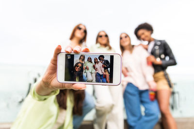 Woman photographing with mobile phone