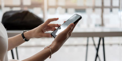 Midsection of woman using mobile phone