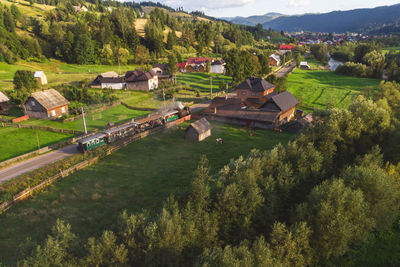 High angle view of trees and houses on field